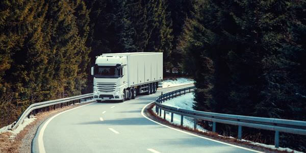 Klaviertransport Pfungstadt: Lkw fährt auf einer kurvigen Straße durch den Wald